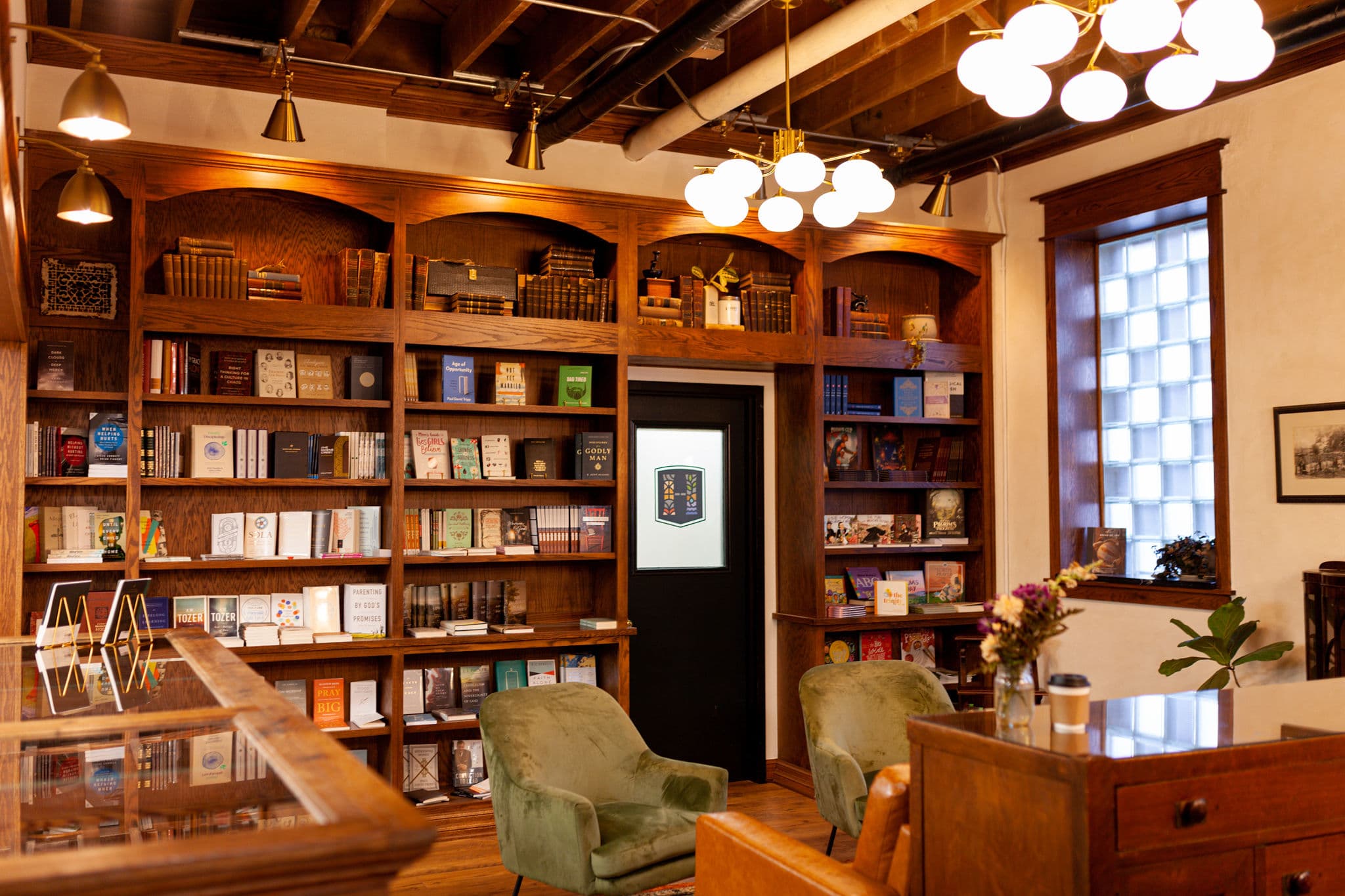 A warm and inviting bookstore featuring wooden shelves lined with books, soft lighting, and comfortable seating, perfect for reading and reflection.